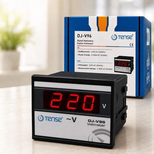 A Tense DJ-V96 digital voltmeter with a red LED display showing 220V, placed in front of its blue and white retail packaging box on a light wooden surface.

